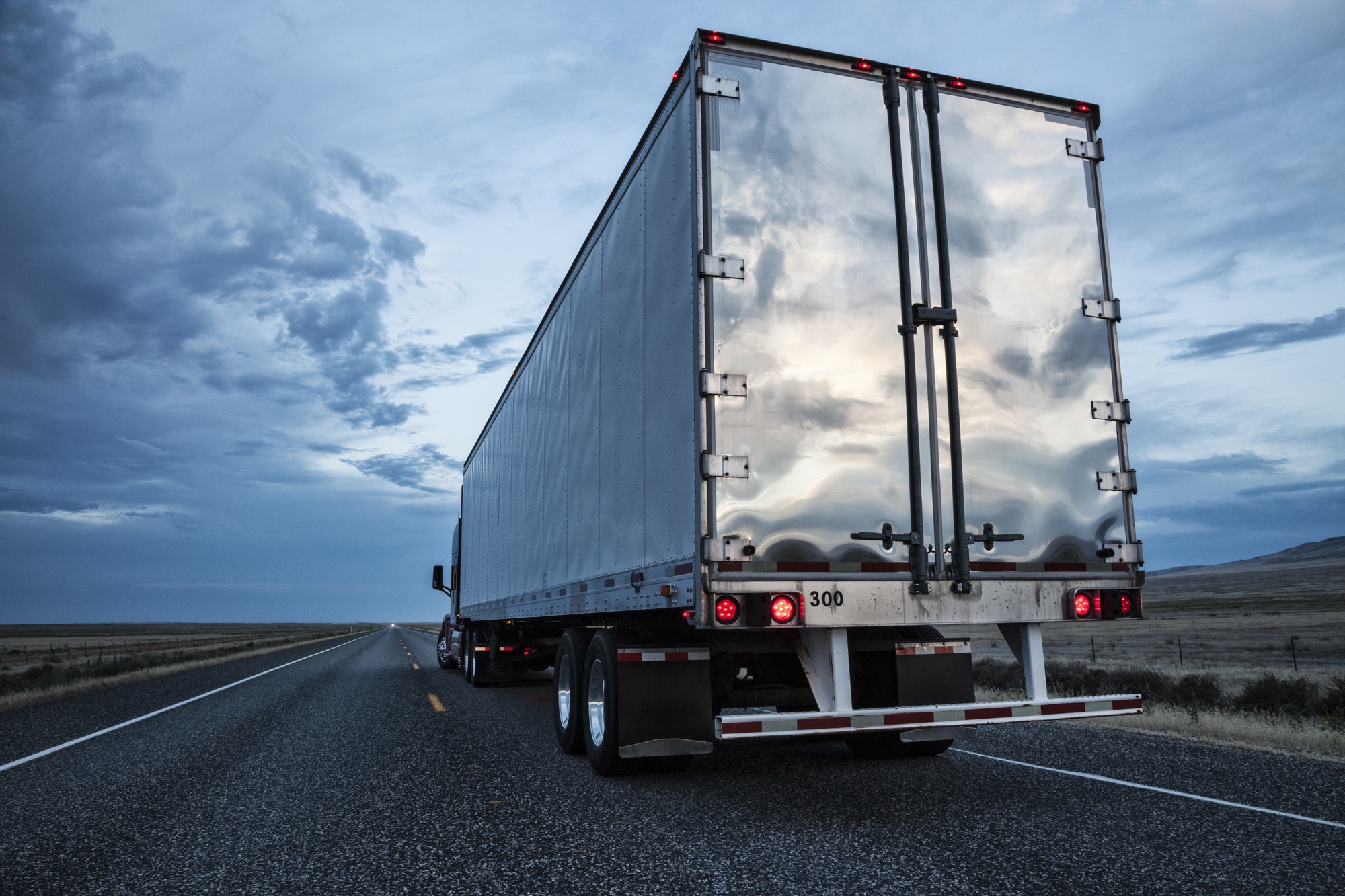 rear-view-of-the-trailer-on-a-class-8-commercial-truck-on-the-highway